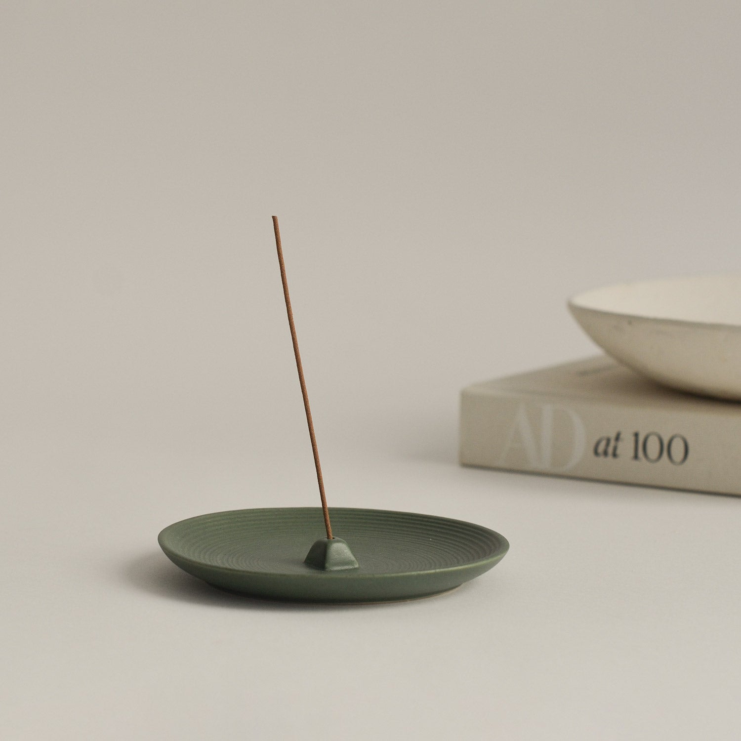 green ceramic wheel-thrown incense holder with Japanese incense