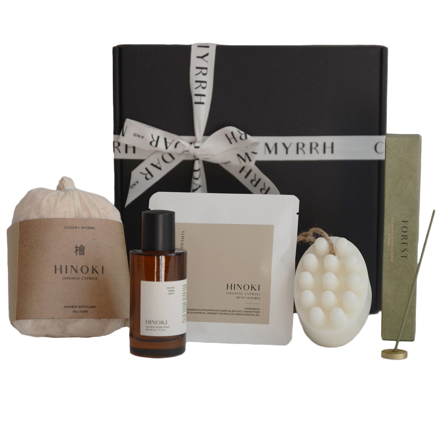 Collection of Hinoki products including a bottle, candle, and incense on a white background