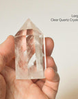 holding large clear quartz crystal