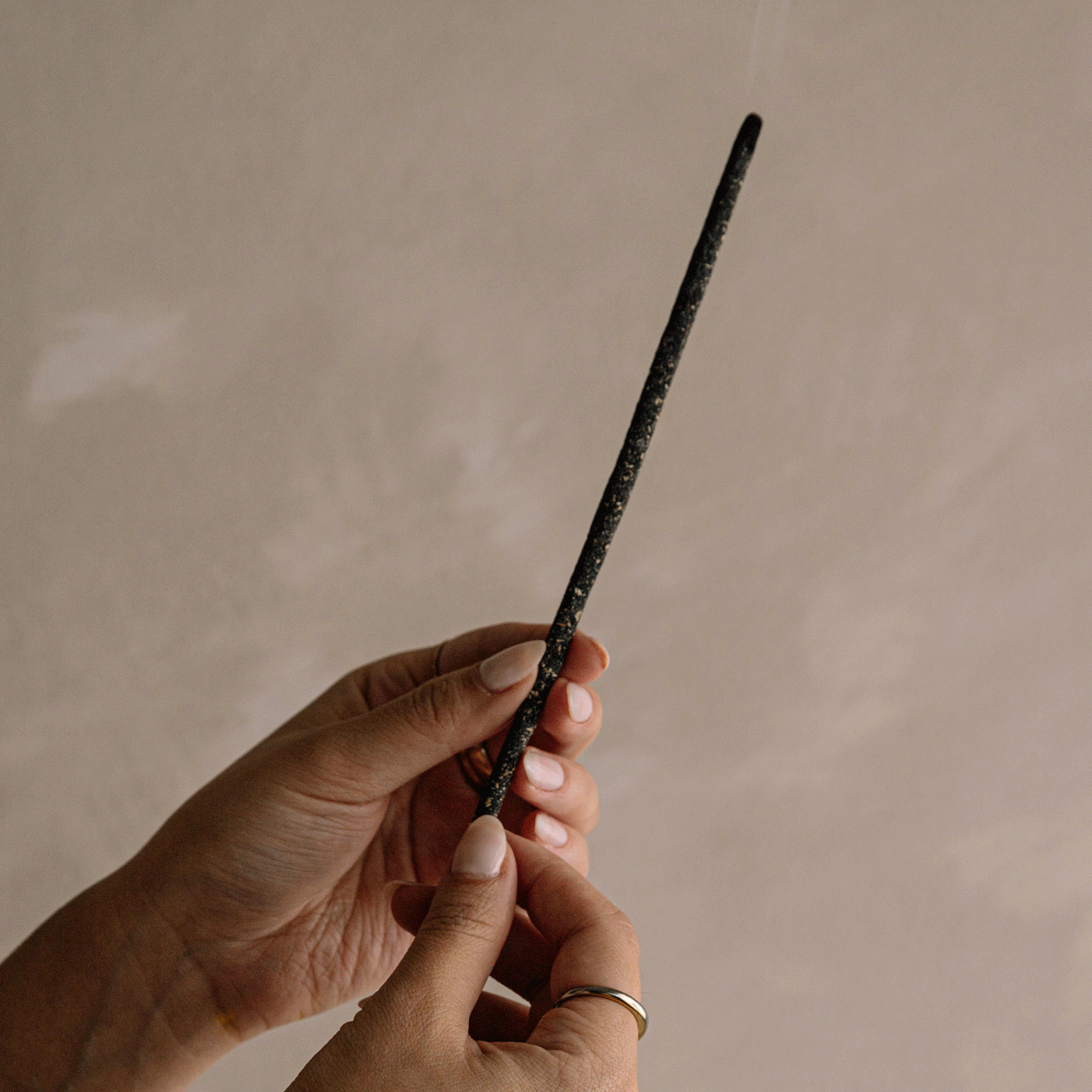 A gif showing the process of burning black copal incense stick.