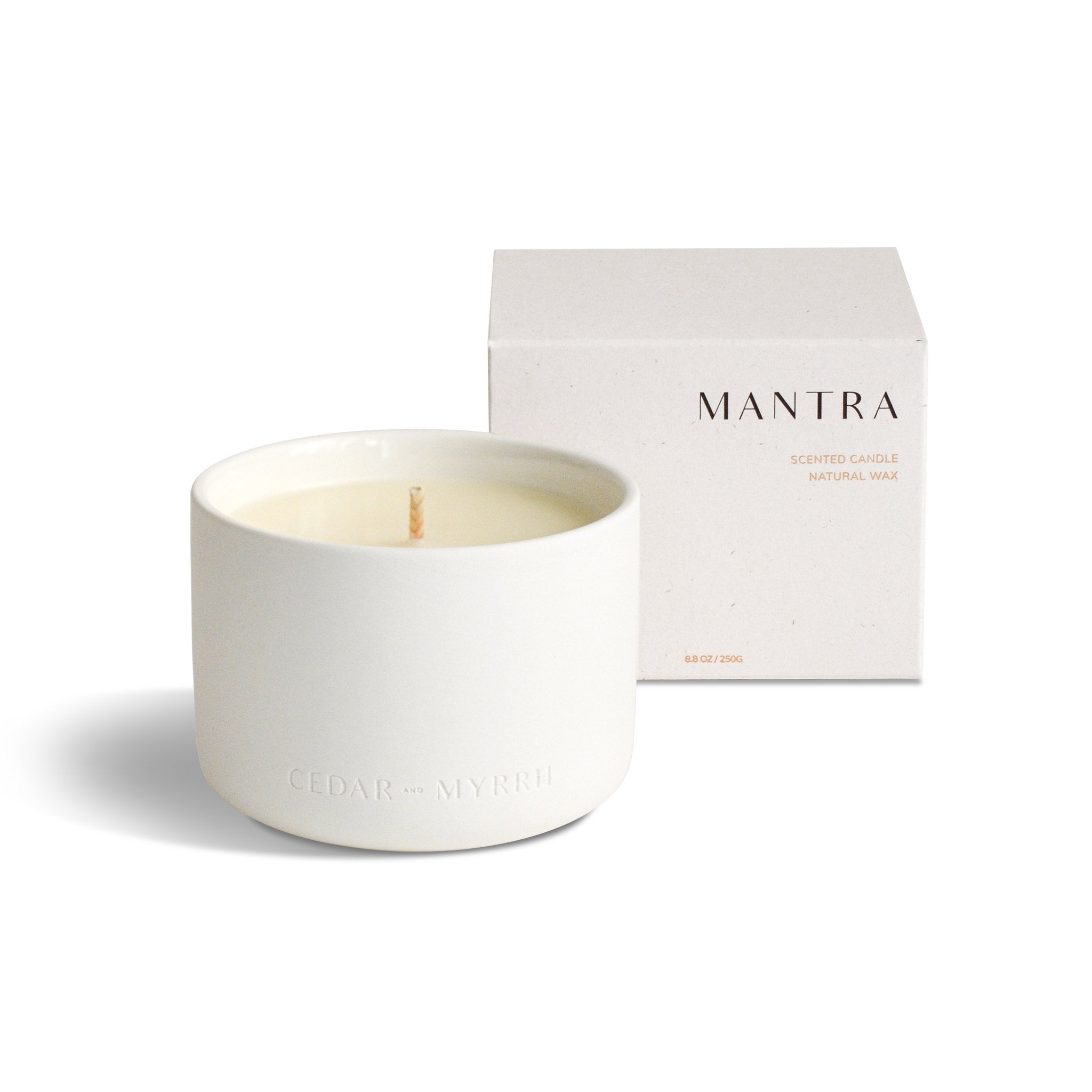 mantra wellness candle with packaging box behind