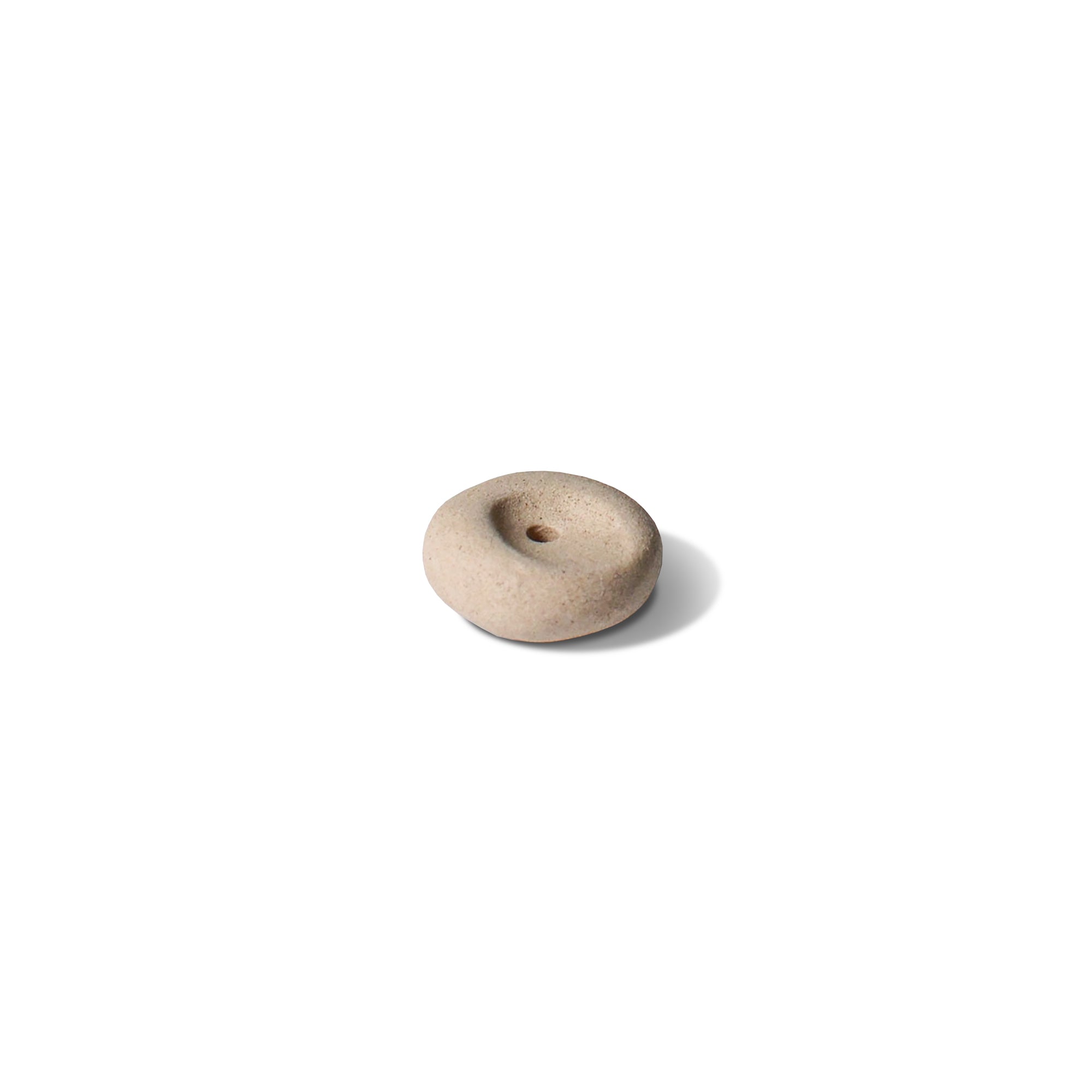 Pebble-shaped mini incense holder made of beige ceramic