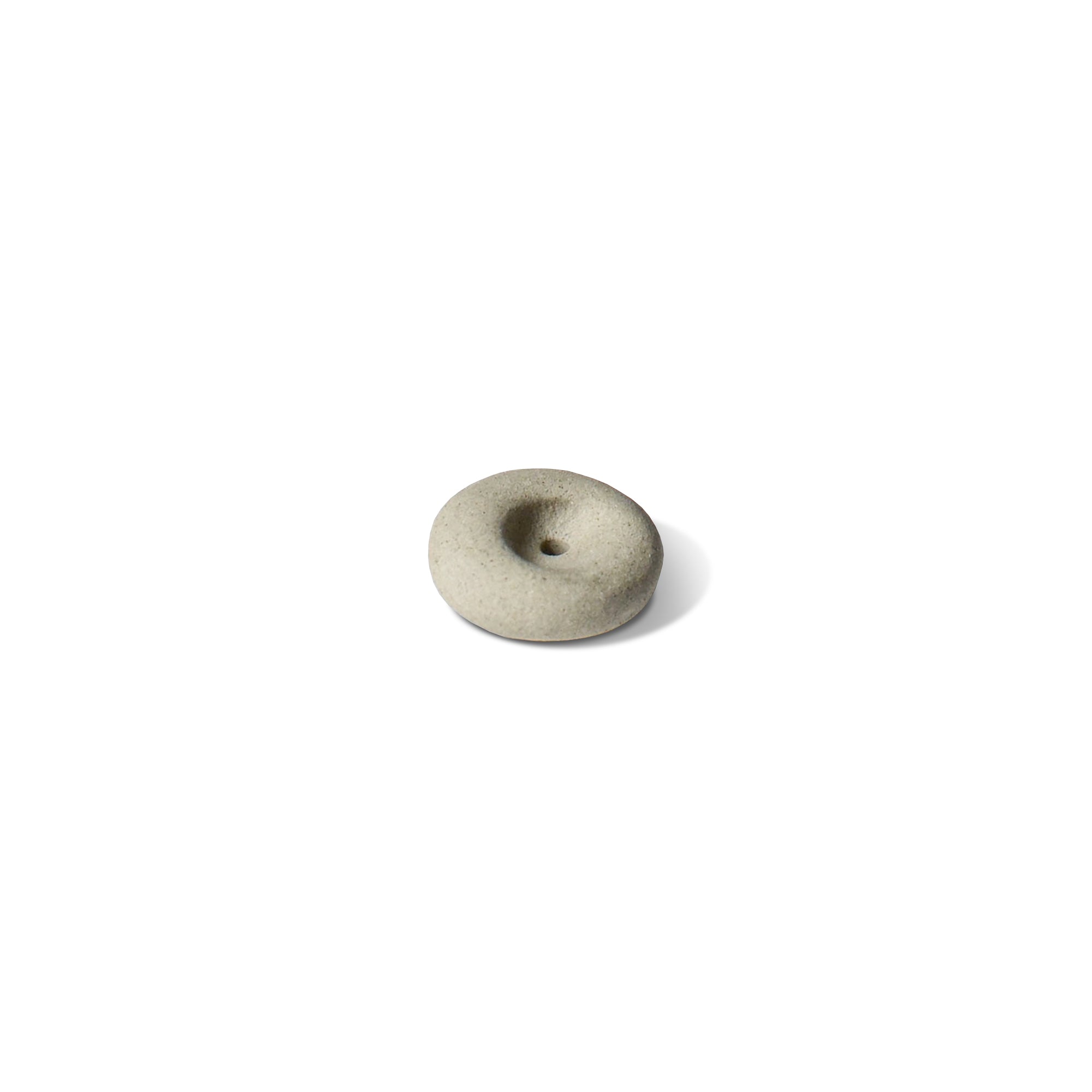 a mini light grey ceramic pebble-shaped incense holder