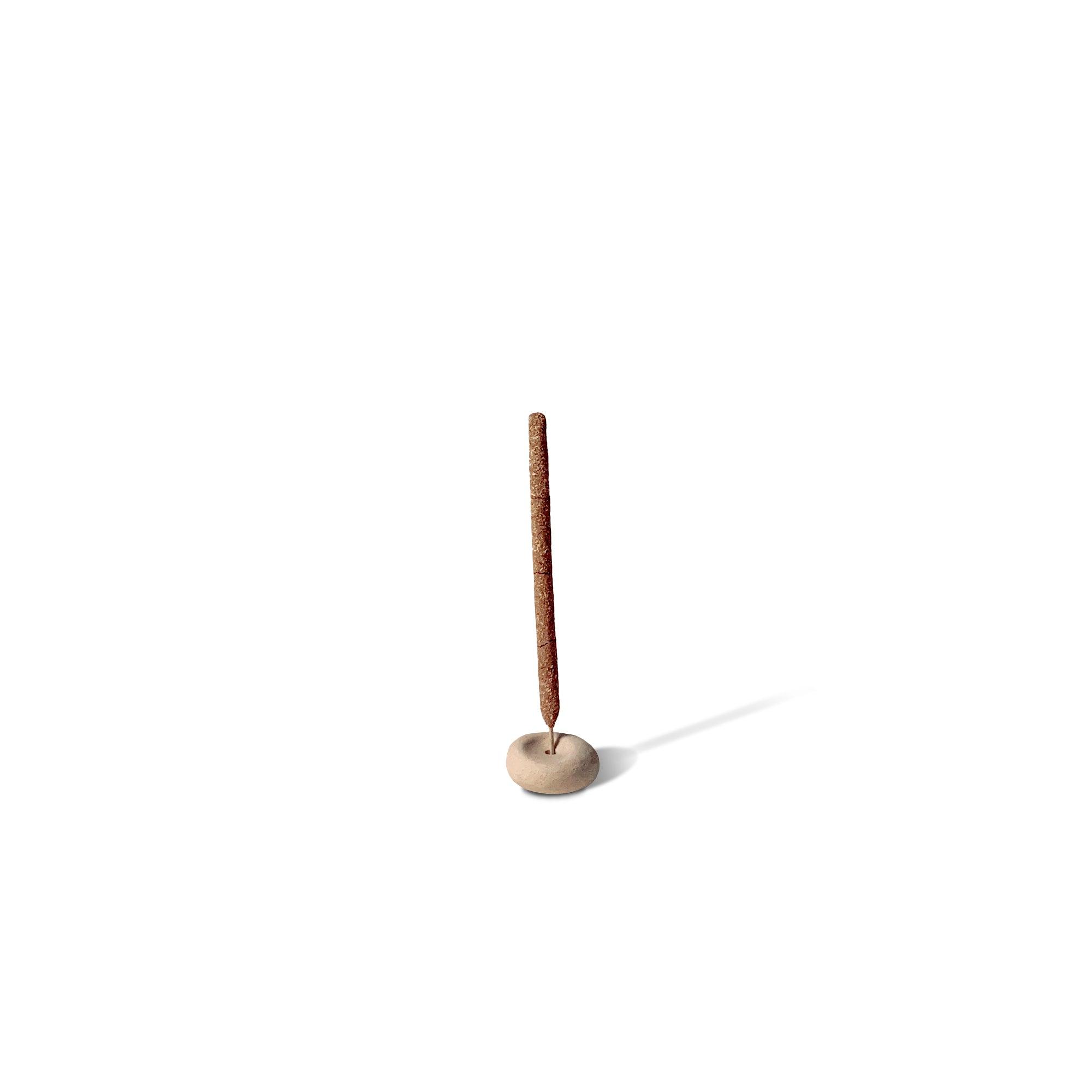 a mini beige pebble shaped ceramic incense holder