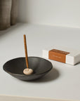 Left: mini cinnamon incense stick with mini pebble holder inside the smudging bowl; Right: package of mini cinnamon incense stick.