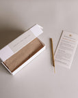 Left: opened package with mini incense sticks; Right: mini incense stick made of white sage plant and pamphlet.