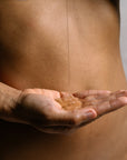 Organic body wash gel poured into hand, showing clear texture and gentle cleansing formula.