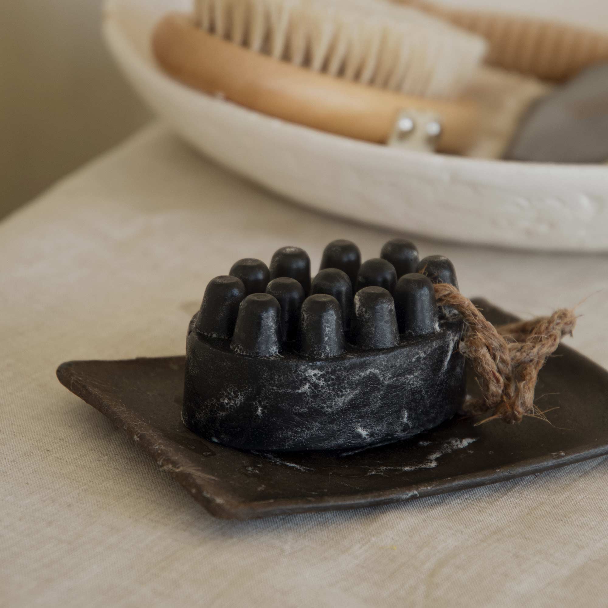 palo santo charcoal bar soap with a plate in the bathroom