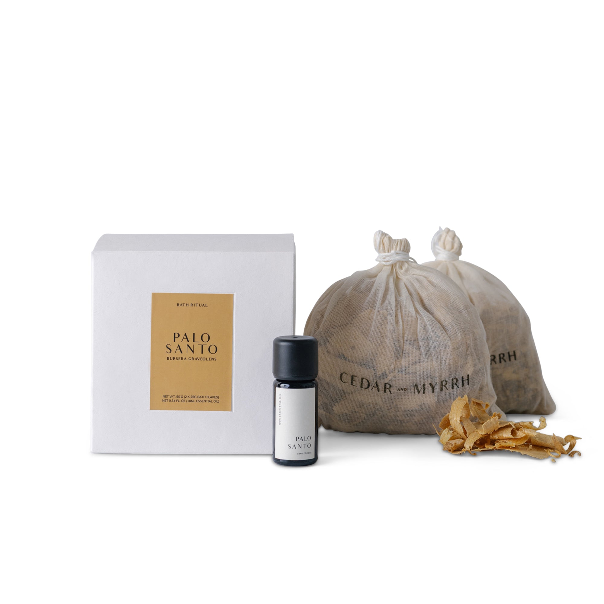 Cedar and Myrrh Palo Santo Bath Flake and Essential Oil Ritual Set featuring two bags of Palo Santo woodBath  flakes, one bottle of pure essential oil, and minimalist white packaging