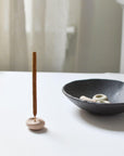 left: mini incense stick with mini incense holder beige pebble, Right: 3 pebble-shaped incense holders on the incense bowl