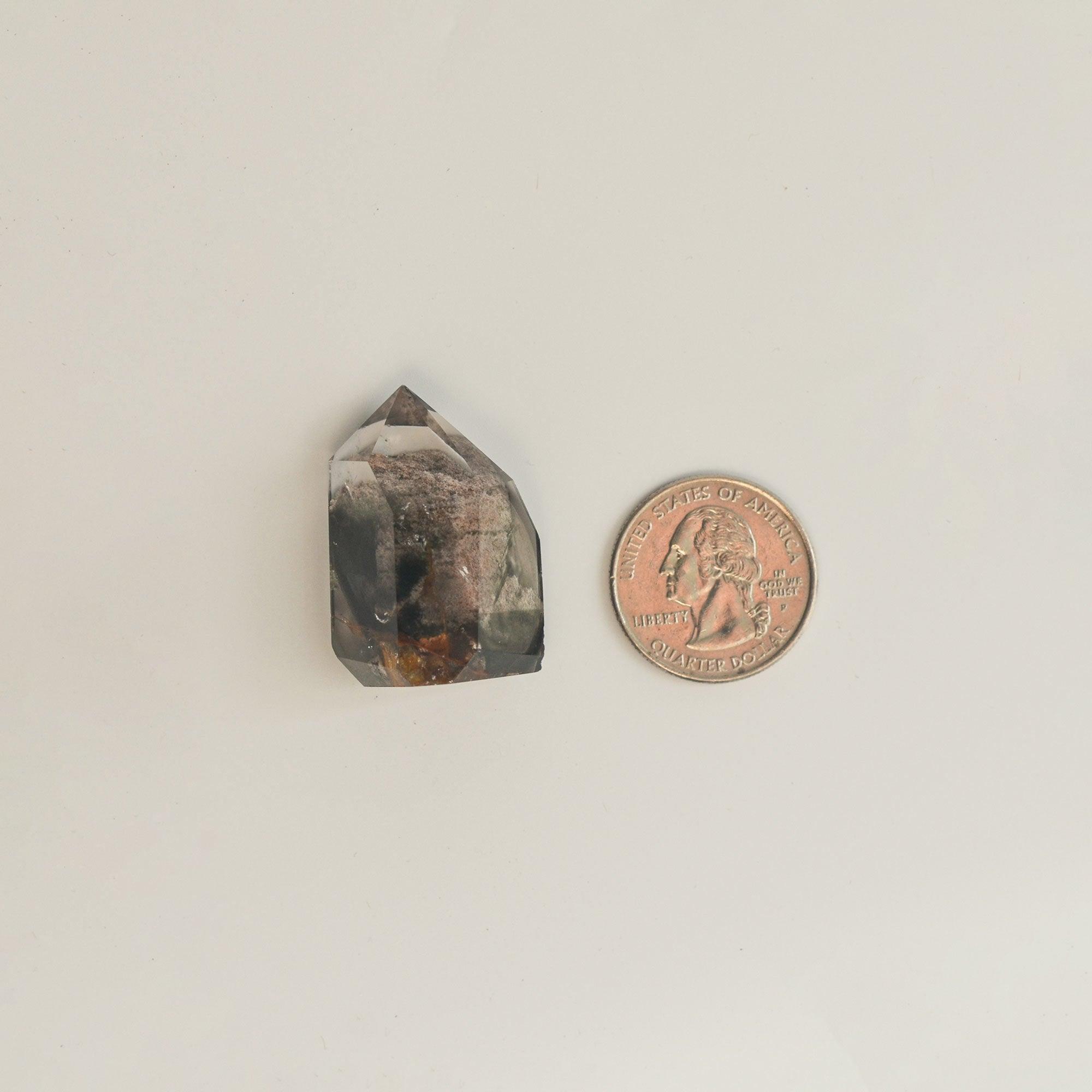 mini crystal of phantom quartz with quarter dollar coin