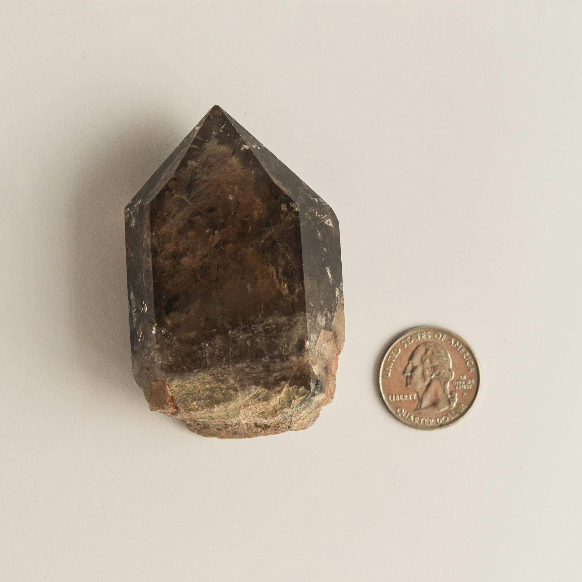 large phantom quartz crystal and quarter dollar coin