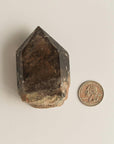 large phantom quartz crystal and quarter dollar coin