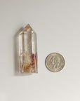 long transparent phantom quartz and quarter dollar coin