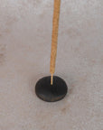 raw black clay pebble incense holder with incense stick