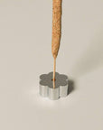 polished silver incense holder with incense stick