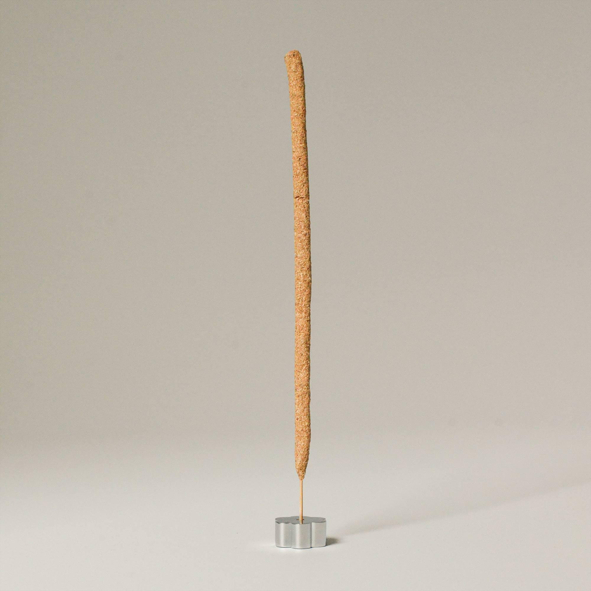 palo santo incense stick with polished silver incense holder