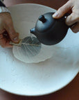 Pouring tea using a tea strainer