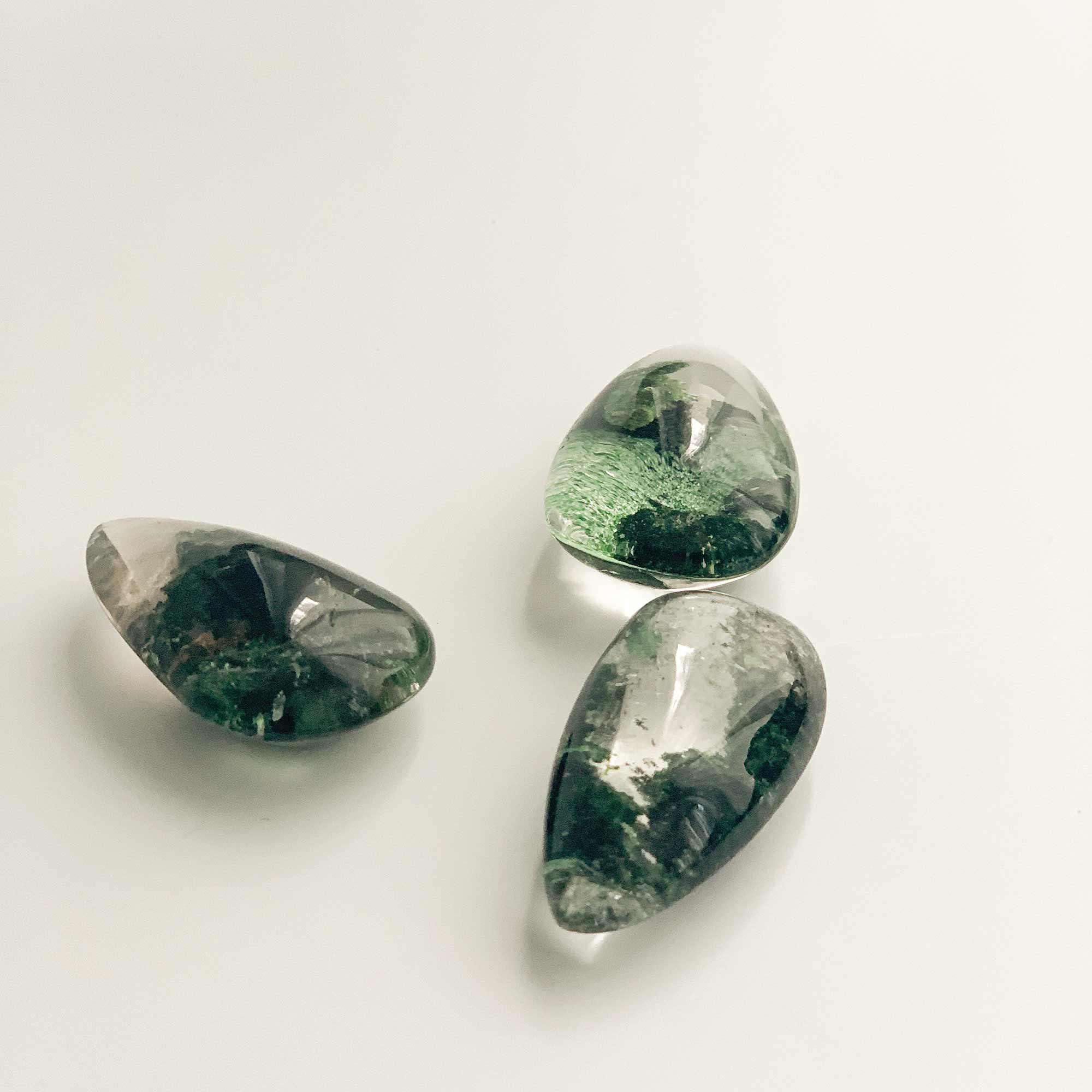 three medium green ghost crystals with different pattern
