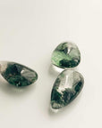 three medium green ghost crystals with different pattern