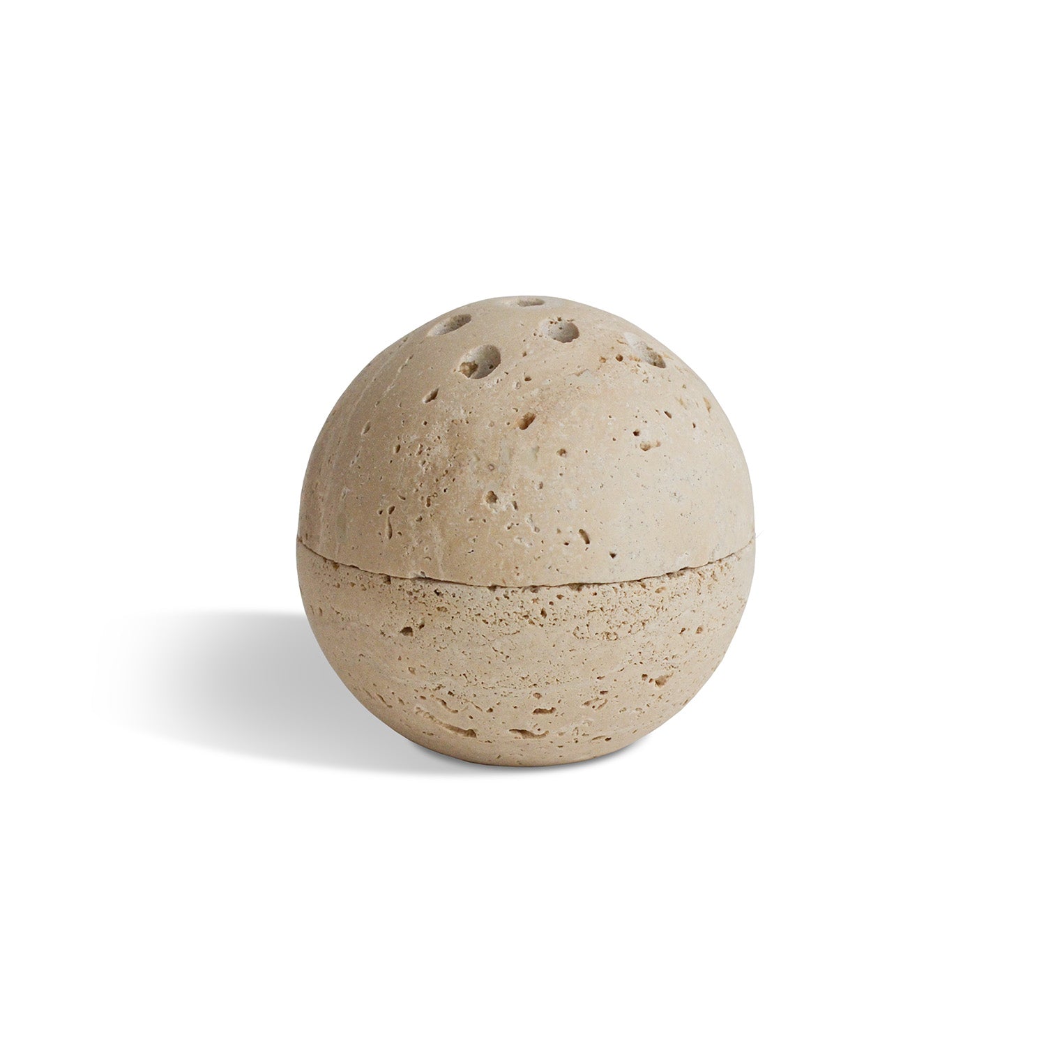 A rustic travertine sphere incense and smudging burner