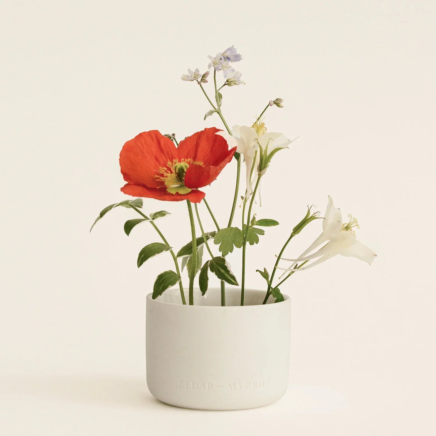 Floral arrangement in a white ceramic jar