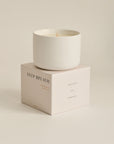 Candle with packaging labeled 'DEEP BREATH'