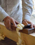 Craftsman cutting wood for bath flakes